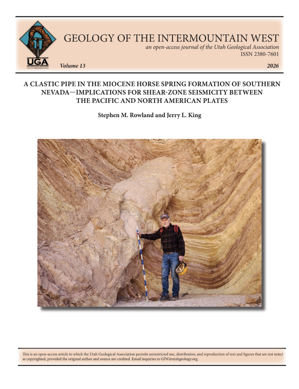 Stephen M. Rowland stands next to the Lowell Wash clastic  pipe—a seismically triggered clastic pipe oriented perpen- dicular to bedding in the Miocene Horse Spring Formation  of southern Nevada. Rod is 1.5 m long, calibrated in dm. Photograph by Gregg Wilkerson.